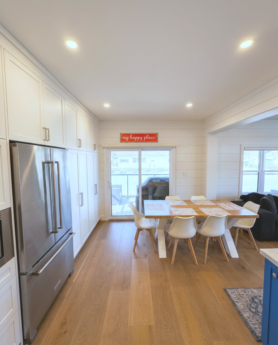 Dining area with floor-to-ceiling pantry and walkout to deck
