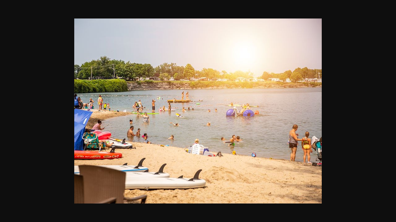 Turquoise quarry lagoon with paddleboarders at Sherkston Shores